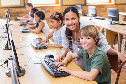 Cute pupils in computer class with teacher