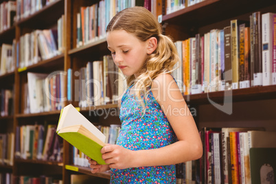 Girl reading book in library