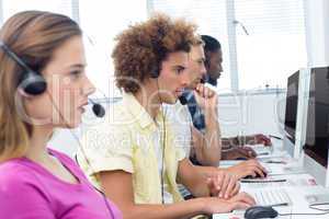 Students using headsets in computer class