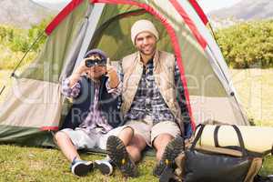 Father and son beside their tent