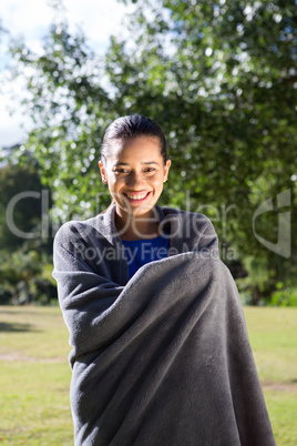 Pretty woman wrapped in blanket