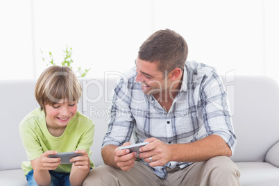 Father and son playing games on cell phone