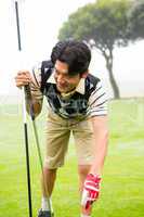 Golfer placing golf ball on tee