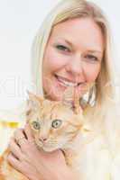 Happy woman holding cat on white background