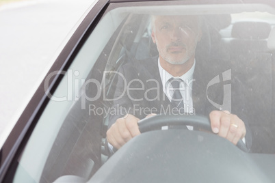 Focused man sitting at the wheel