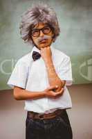 Thoughtful little boy dressed as senior teacher
