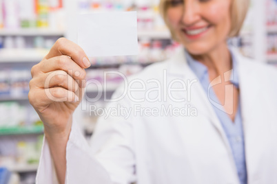 Smiling pharmacist showing calling card