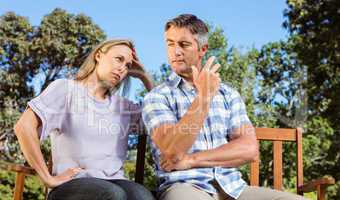 Couple having an argument on park bench