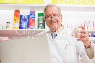 Smiling senior holding medication