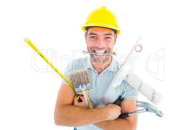 Portrait of smiling handyman holding various tools