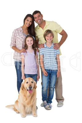 Happy family standing with dog