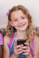 Cute pupil using mobile phone