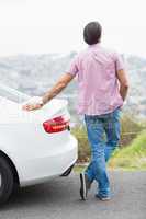 Man standing next to his car