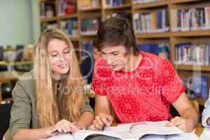 College students doing homework in library