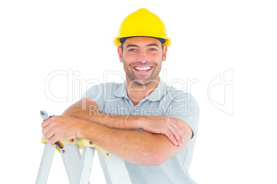 Happy repairman with pliers on ladder