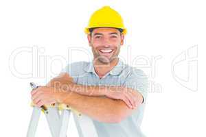 Happy repairman with pliers on ladder