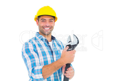 Portrait of smiling handyman holding adjustable spanner