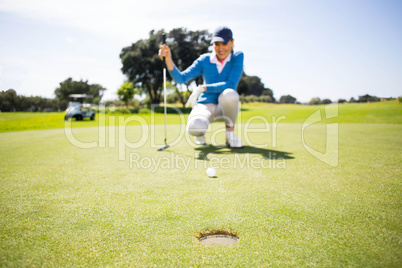 Female golfer putting her ball