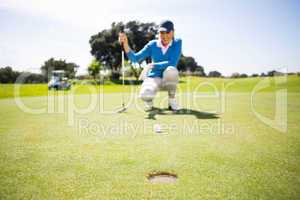 Female golfer putting her ball