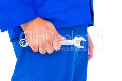 Mechanic holding spanners on white background