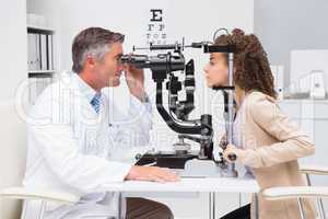 Woman doing eye test with optometrist