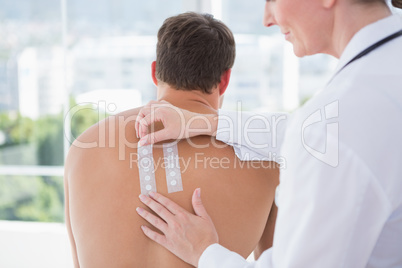 Doctor doing skin test to her patient