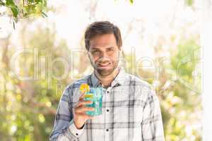 Happy man smiling at camera with drink