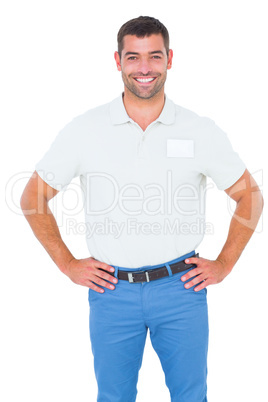 Smiling male technician standing hands on hip