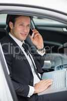 Businessman working in the drivers seat