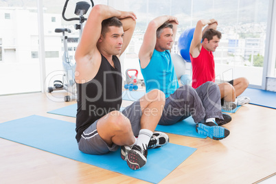 Group of men working on exercise mat