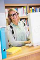 Pretty librarian smiling at camera