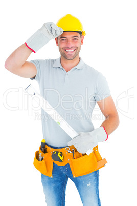 Smiling handyman holding spirit level