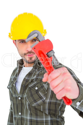 Manual worker looking through monkey wrench