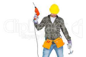 Repairman holding hammer and drill machine