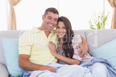 Romantic couple embracing in house