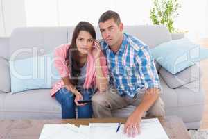 Portrait of worried couple calculating home finances