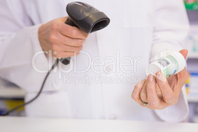 Pharmacist scanning medication with a scanner