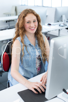 Smiling female student in computer class