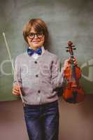 Portrait of cute little boy holding violin