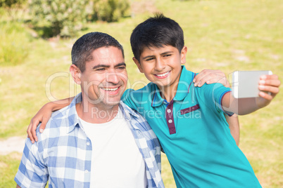 Father and son in the countryside taking selfie