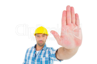 Confident manual worker gesturing stop sign
