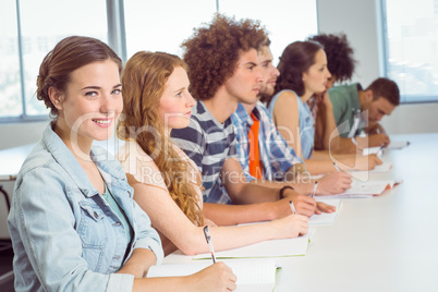 Fashion students taking notes in class Fashion students taking notes in class