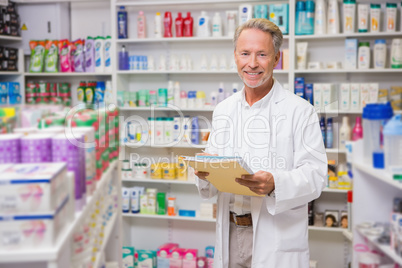 Senior pharmacist holding documents