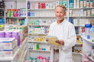 Senior pharmacist holding documents