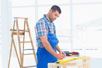 Handyman working at workbench in office