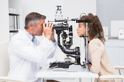 Woman doing eye test with optometrist
