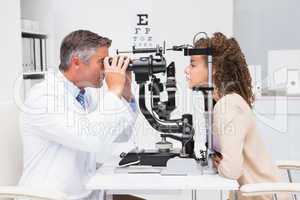 Woman doing eye test with optometrist