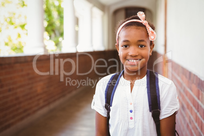 Little girl smiling in school corridor