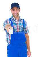 Portrait of happy handyman giving visiting card