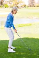 Female golfer taking a shot